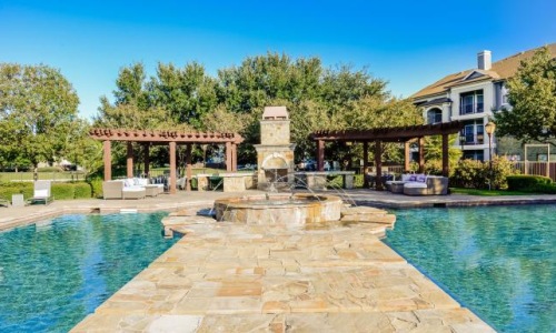 a swimming pool with a house in the background