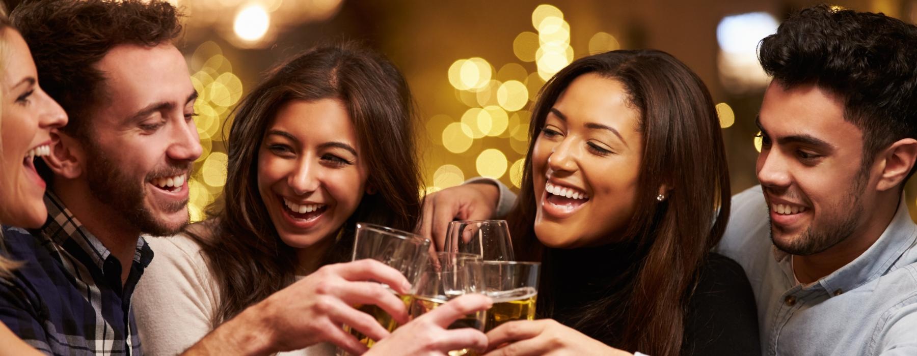 a group of people drinking wine