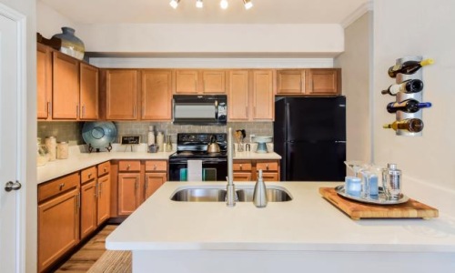 a kitchen with wooden cabinets