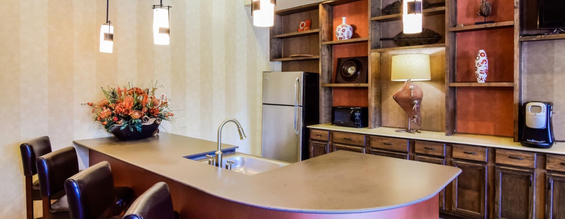a kitchen with a bar and a table
