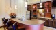 a kitchen with a bar and a table
