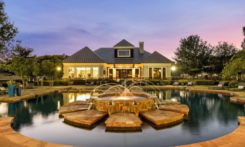 a house with a fountain in the front