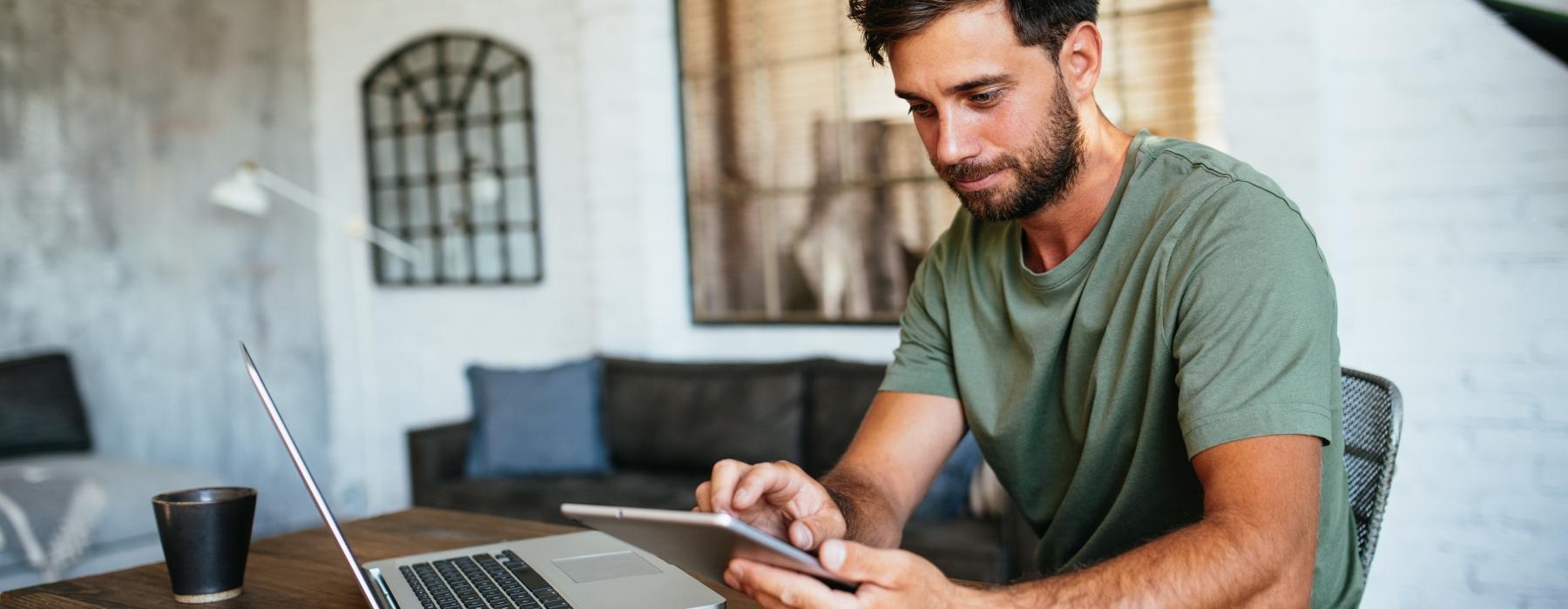 a man sitting at a table with a laptop