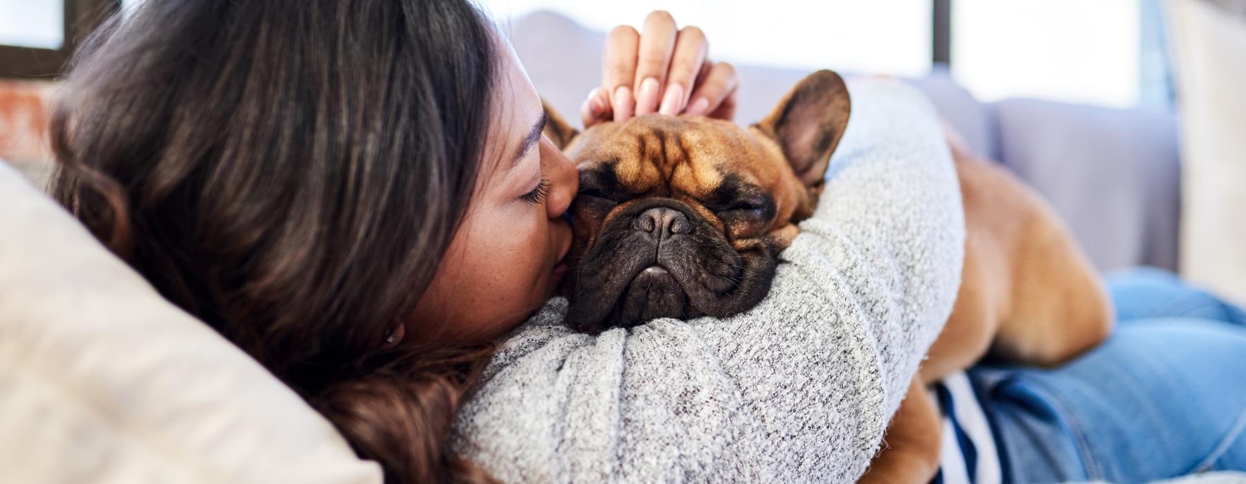 a person sleeping with a dog
